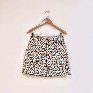 J.crew mercantile mini skirt with cream, red, yellow and green floral patterns.